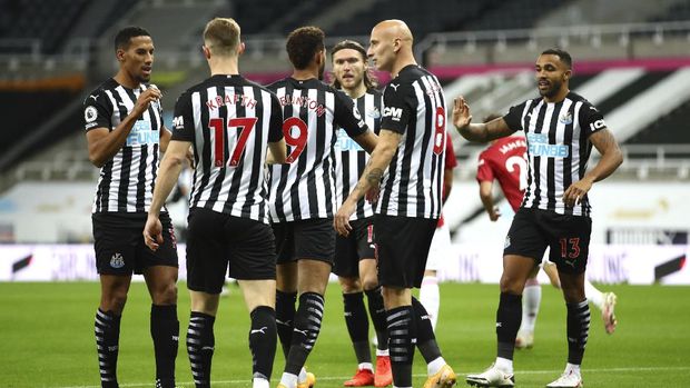 Newcastle players celebrate after Manchester United's Luke Shaw scored an own goal during the English Premier League soccer match between Newcastle United and Manchester United at St. James' Park in Newcastle, England, Saturday, Oct. 17, 2020. (Alex Pantling/Pool via AP)