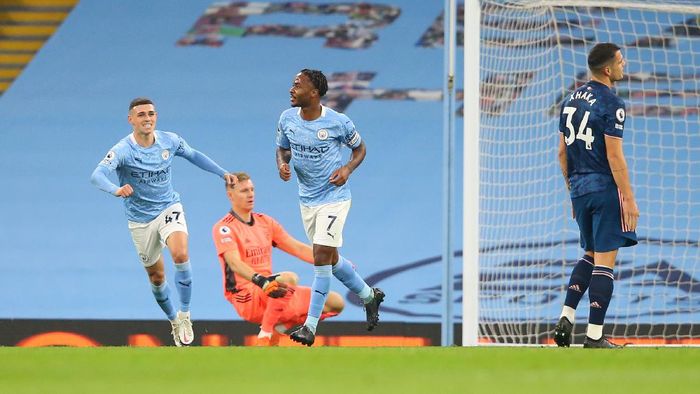 manchester city raheem sterling manchester city vs arsenal liga inggris premier league MANCHESTER, ENGLAND - OCTOBER 17: Raheem Sterling of Manchester City celebrates after scoring his teams first goal during the Premier League match between Manchester City and Arsenal at Etihad Stadium on October 17, 2020 in Manchester, England. Sporting stadiums around the UK remain under strict restrictions due to the Coronavirus Pandemic as Government social distancing laws prohibit fans inside venues resulting in games being played behind closed doors. (Photo by Alex Livesey/Getty Images)
