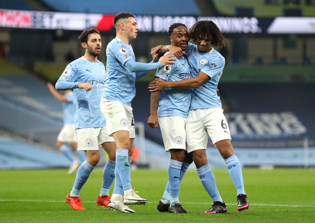 MANCHESTER, ENGLAND - OCTOBER 17: Raheem Sterling of Manchester City celebrates with his teammates after scoring his team's first goal during the Premier League match between Manchester City and Arsenal at Etihad Stadium on October 17, 2020 in Manchester, England.  Sports stadiums across the UK remain under strict restrictions due to the coronavirus pandemic, as the government's social distancing laws prohibit fans within venues, causing games to be played behind closed doors.  (Photo by Martin Rickett - Pool / Getty Images)