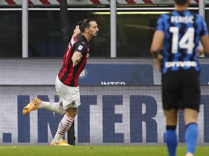 AC Milans Zlatan Ibrahimovic celebrates after scoring his sides second goal during the Serie A soccer match between Inter Milan and AC Milan at the San Siro Stadium, in Milan, Italy, Saturday, Oct. 17, 2020. (AP Photo/Antonio Calanni)
