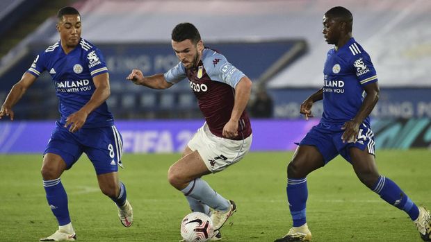 Aston Villa's John McGinn fights for the ball against Leicester's Youri Tielemans and Nampalys Mendy, right, during the English Premier League soccer match between Leicester City and Aston Villa at the King Power Stadium in Leicester, England, Sunday, Oct. 18, 2020. (AP Photo/Rui Vieira, Pool)