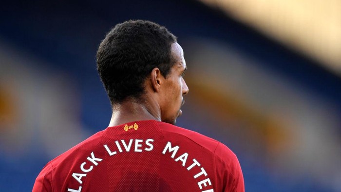 LIVERPOOL, ENGLAND - JUNE 21: Joel Matip of Liverpool looks on with Black Lives Matter movement on his shirt during the Premier League match between Everton FC and Liverpool FC at Goodison Park on June 21, 2020 in Liverpool, England. Football Stadiums around Europe remain empty due to the Coronavirus Pandemic as Government social distancing laws prohibit fans inside venues resulting in all fixtures being played behind closed doors. (Photo by Peter Powell/Pool via Getty Images)