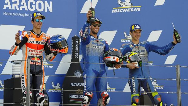 Suzuki rider Alex Rins, center, of Spain, winner of the Aragon Motorcycle Grand Prix, celebrates win the podium with second placed Honda rider Alex Marquez, left, of Spain, and third placed Suzuki rider Joan Mir, of Spain, at the Motorland circuit in Alcaniz, Spain, Sunday, Oct. 18, 2020. (AP Photo/Jose Breton)