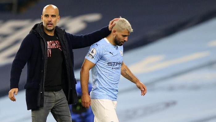 Manchester Citys Sergio Aguero passes by Manchester Citys head coach Pep Guardiola after being substituted during the English Premier League soccer match between Manchester City and Arsenal at the Etihad stadium in Manchester, England, Saturday, Oct. 17, 2020. (Alex Livesey/Pool via AP)