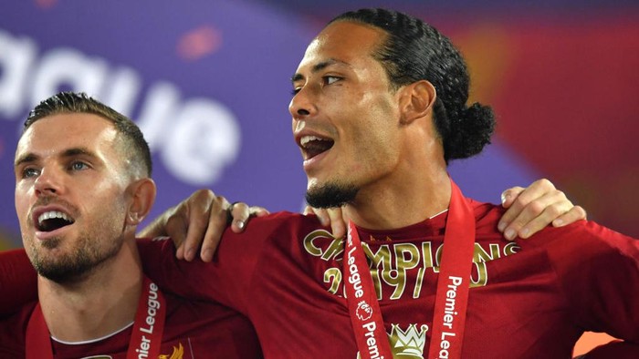 LIVERPOOL, ENGLAND - JULY 22: Jordan Henderson and Virgil van Dijk of Liverpool celebrate following the Premier League match between Liverpool FC and Chelsea FC at Anfield on July 22, 2020 in Liverpool, England. Football Stadiums around Europe remain empty due to the Coronavirus Pandemic as Government social distancing laws prohibit fans inside venues resulting in all fixtures being played behind closed doors. (Photo by Paul Ellis/Pool via Getty Images)