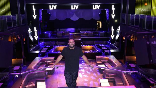 LIV owner David Grutman poses for a photograph at the nightclub, Wednesday, Oct. 14, 2020, in Miami Beach, Fla. LIV, one of Miami's most glamorous, star-studded nightclubs sits empty and quiet these days, a casualty of both the coronavirus outbreak and a power struggle between state and local government over how to contain the scourge. (AP Photo/Lynne Sladky)