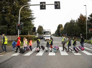 Relawan Bantu Siswa Italia Jaga Jarak Dengan Tali