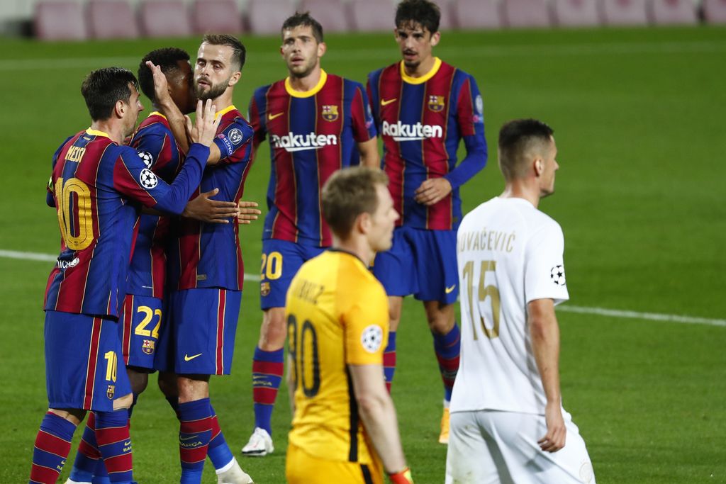 Barcelona players celebrate the second goal of their team during the Champions League group G soccer match between FC Barcelona and Ferencvaros at the Camp Nou stadium in Barcelona, Spain, Tuesday, Oct. 20, 2020. (AP Photo/Joan Monfort)