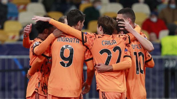 Juventus' Alvaro Morata, center left, celebrates after scoring his side's second goal during the Champions League, group G, soccer match between Dynamo Kyiv and Juventus at the Olimpiyskiy Stadium in Kyiv, Ukraine, Tuesday, Oct. 20, 2020. (Valentyn Ogirenko/Pool via AP)