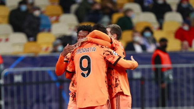 Alvaro Morata of Juventus, center, celebrates after scoring his team's second goal during the Champions League group G soccer match between Dynamo Kyiv and Juventus at the Olimpiyskiy Stadium in Kiev, Ukraine, on Tuesday 20 October 2020 (Valentyn Ogirenko / Pool via AP)