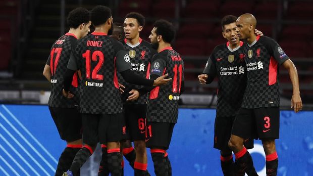 Liverpool's Trent Alexander-Arnold, center, no 66, celebrates with teammates after scoring during the group D Champions League soccer match between Ajax and Liverpool at the Johan Cruyff ArenA in Amsterdam, Netherlands, Wednesday, Oct. 21, 2020. (AP Photo/Peter Dejong)