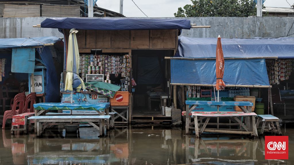 Warga beraktivitas saat banjir rob di Pelabuhan Kali Adem, Muara Angke, Jakarta, Kamis, 22 Oktober 2020. Banjir yang terjadi sejak Senin (19/10) itu dikarenakan pasang surut air laut. CNN Indonesia/Bisma Septalisma