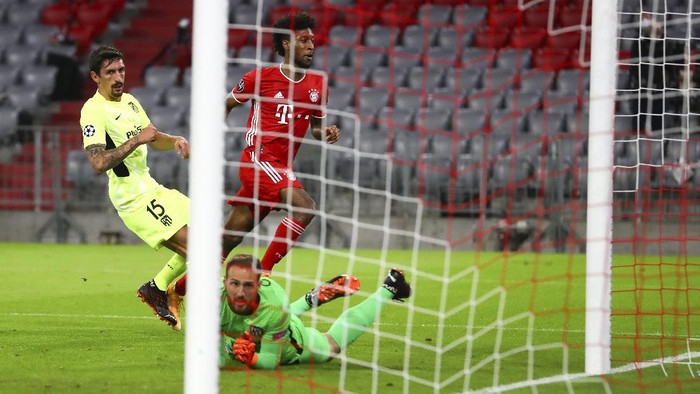 Bayern Munichs Kingsley Coman, centre, kicks the ball past Atletico Madrids Stefan Savic, left, and goalkeeper Jan Oblak to score his teams first goal during the Champions League Group A soccer match between Bayern Munich and Atletico Madrid at the Allianz Arena in Munich, Germany, Wednesday, Oct. 21, 2020. (AP Photo/Matthias Schrader,Pool)