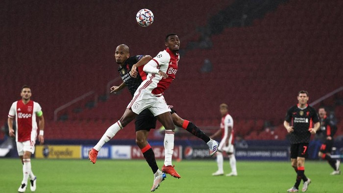 Liverpools Brazilian midfielder Fabinho (L) jumps for the ball with Ajaxs Dutch midfielder Ryan Gravenberch  during the UEFA Champions League Group D first-leg football match between Ajax Amsterdam and Liverpool FC at the Johan Cruijff Arena in Amsterdam on October 21, 2020. (Photo by KENZO TRIBOUILLARD / AFP)