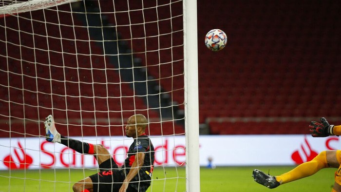 Liverpools Fabinho, saves from the goal line after a header from Ajaxs captain Dusan Tadic from scoring during the group D Champions League soccer match between Ajax and Liverpool at the Johan Cruyff ArenA in Amsterdam, Netherlands, Wednesday, Oct. 21, 2020. (AP Photo/Peter Dejong)