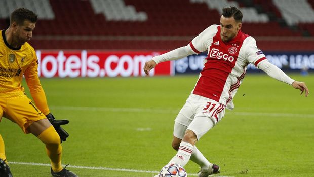 Ajax's Nicolas Tagliafico, right, tries to score against Liverpool's goalkeeper Adrian, during the group D Champions League soccer match between Ajax and Liverpool at the Johan Cruyff ArenA in Amsterdam, Netherlands, Wednesday, Oct. 21, 2020. (AP Photo/Peter Dejong)