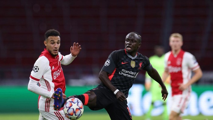 Ajaxs Moroccan defender Noussair Mazraoui (L) vies for the ball with Liverpools Senegalese forward Sadio Mane during the UEFA Champions League Group D first-leg football match between Ajax Amsterdam and Liverpool FC at the Johan Cruijff Arena in Amsterdam on October 21, 2020. (Photo by Kenzo Tribouillard / AFP)