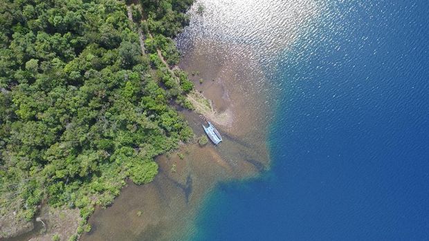 Aerial view of Sungai Dingin (Cold River) beside the Matano lake. The deepest lake in South East Asia; where the deepest point if 590 meters.