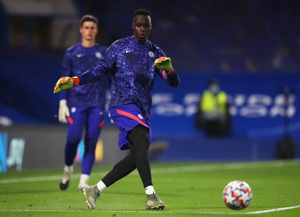 LONDON, ENGLAND - OCTOBER 20: Edouard Mendy of Chelsea rolls the ball out during the UEFA Champions League Group E stage match between Chelsea FC and FC Sevilla at Stamford Bridge on October 20, 2020 in London, England. Sporting stadiums around the UK remain under strict restrictions due to the Coronavirus Pandemic as Government social distancing laws prohibit fans inside venues resulting in games being played behind closed doors. (Photo by Glyn Kirk - Pool/Getty Images)