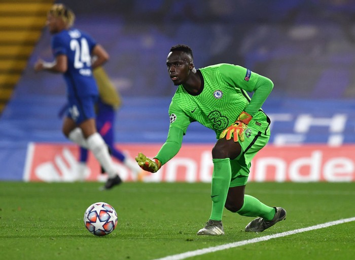 LONDON, ENGLAND - OCTOBER 20: Edouard Mendy of Chelsea rolls the ball out during the UEFA Champions League Group E stage match between Chelsea FC and FC Sevilla at Stamford Bridge on October 20, 2020 in London, England. Sporting stadiums around the UK remain under strict restrictions due to the Coronavirus Pandemic as Government social distancing laws prohibit fans inside venues resulting in games being played behind closed doors. (Photo by Glyn Kirk - Pool/Getty Images)