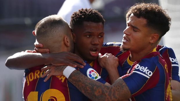 Barcelona's Ansu Fati celebrates with team mates scoring his side's first goal during the Spanish La Liga soccer match between FC Barcelona and Real Madrid at the Camp Nou stadium in Barcelona, Spain, Saturday, Oct. 24, 2020. (AP Photo/Joan Monfort)