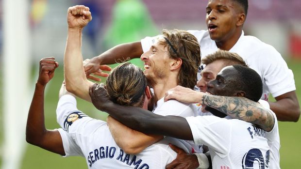 Real Madrid's Luka Modric celebrates scoring his side's 3rd goal during the Spanish La Liga soccer match between FC Barcelona and Real Madrid at the Camp Nou stadium in Barcelona, Spain, Saturday, Oct. 24, 2020. (AP Photo/Joan Monfort)