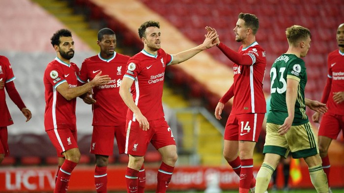 LIVERPOOL, ENGLAND - OCTOBER 24: Diogo Jota of Liverpool celebrates with teammates after scoring his teams second goal during the Premier League match between Liverpool and Sheffield United at Anfield on October 24, 2020 in Liverpool, England. Sporting stadiums around the UK remain under strict restrictions due to the Coronavirus Pandemic as Government social distancing laws prohibit fans inside venues resulting in games being played behind closed doors. (Photo by Stu Forster/Getty Images)
