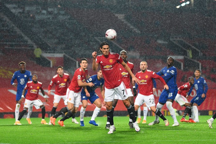 MANCHESTER, ENGLAND - OCTOBER 24: Edinson Cavani of Manchester United clears a ball during the Premier League match between Manchester United and Chelsea at Old Trafford on October 24, 2020 in Manchester, England. Sporting stadiums around the UK remain under strict restrictions due to the Coronavirus Pandemic as Government social distancing laws prohibit fans inside venues resulting in games being played behind closed doors. (Photo by Michael Regan/Getty Images)