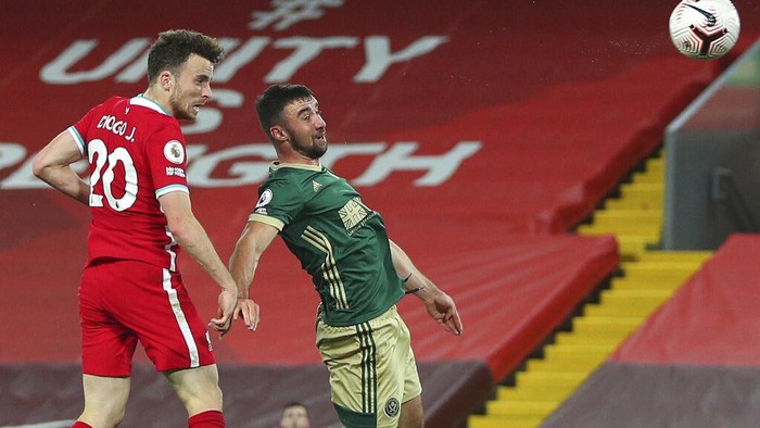 Liverpools Diogo Jota, left heads the ball to score his sides second goal of the game during the English Premier League soccer match between Liverpool and Sheffield United at Anfield in Liverpool, England, Saturday, Oct. 24, 2020. (Peter ByrnePool via AP)