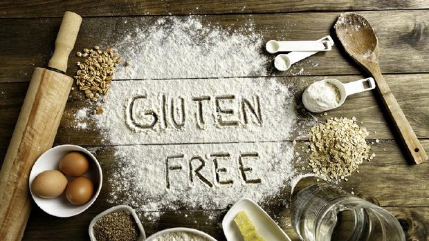 Gluten free bread ingredients and utensils on wood frame background. Gluten sensitivity or non-celiac gluten sensitivity (NCGS) is a health disorder induced by the ingestion of gluten causing intestinal and/or extraintestinal symptoms. It is resolved once the gluten containing food is eliminated from the diet, and when celiac disease and wheat allergy have been alleviated. The pathogenesis of non-celiac gluten sensitivity is not yet well understood. It was hypothesized that gluten, as occurs in celiac disease, is the cause of non-celiac gluten sensitivity. Besides gluten, other components in wheat, rye, barley, and their derivatives may cause the same symptoms.