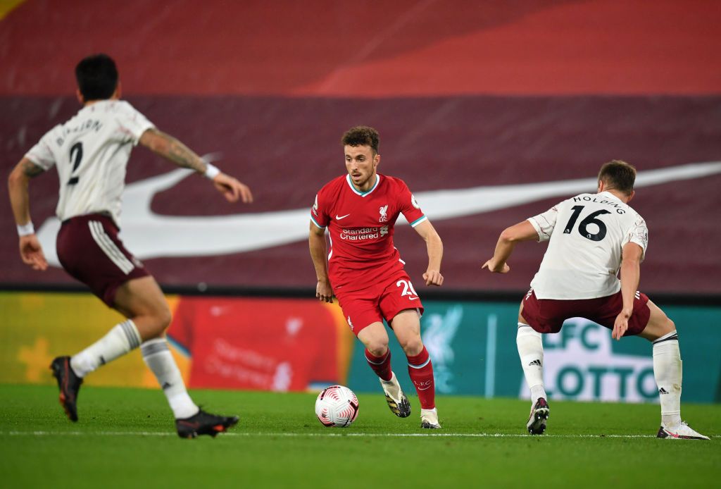 LIVERPOOL, ENGLAND - SEPTEMBER 28: Diogo Jota of Liverpool runs with the ball during the Premier League match between Liverpool and Arsenal at Anfield on September 28, 2020 in Liverpool, England. Sporting stadiums around the UK remain under strict restrictions due to the Coronavirus Pandemic as Government social distancing laws prohibit fans inside venues resulting in games being played behind closed doors. (Photo by Laurence Griffiths/Getty Images)