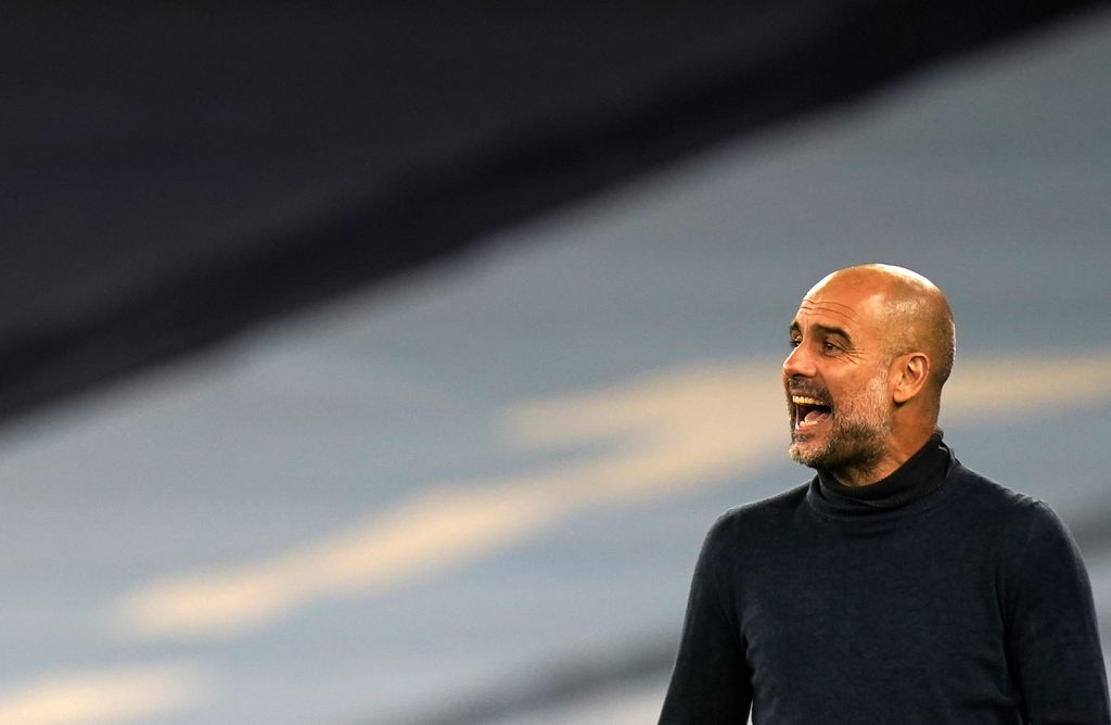 Manchester City's head coach Pep Guardiola gives instructions to his players during the Champions League group C soccer match between Manchester City and FC Porto at the Etihad stadium in Manchester, England, Wednesday, Oct. 21, 2020. (Tim Keeton/Pool via AP)