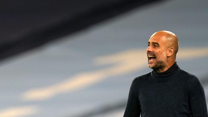 Manchester Citys head coach Pep Guardiola gives instructions to his players during the Champions League group C soccer match between Manchester City and FC Porto at the Etihad stadium in Manchester, England, Wednesday, Oct. 21, 2020. (Tim Keeton/Pool via AP)