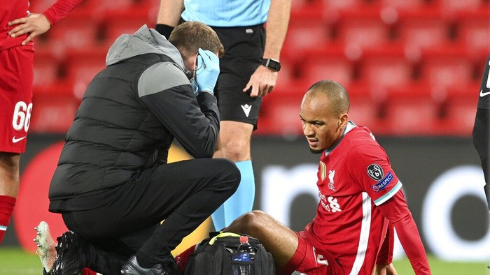 Liverpools Fabinho is treated for an injury during the Champions League Group D soccer match between Liverpool and FC Midtjylland at Anfield stadium, in Liverpool, England, Tuesday, Oct. 27, 2020. (Michael Regan/Pool via AP)