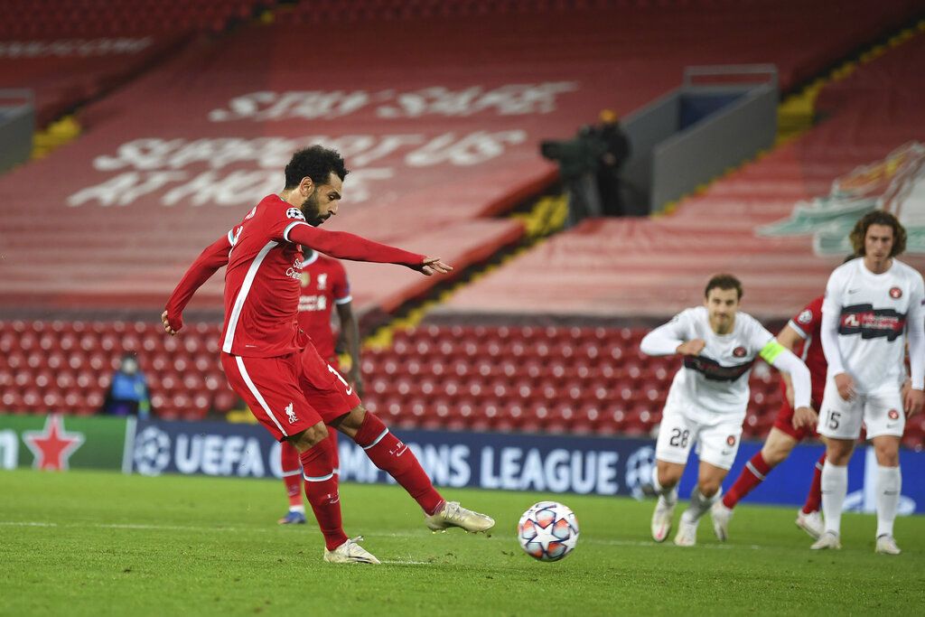 Liverpool's Mohamed Salah scores his side's second goal from a penalty during the Champions League Group D soccer match between Liverpool and FC Midtjylland at Anfield stadium, in Liverpool, England, Tuesday, Oct. 27, 2020. (Michael Regan/Pool via AP)