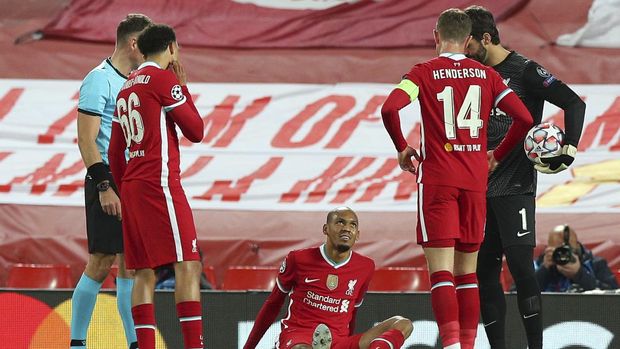 Liverpool's Fabinho sits injured on the pitch during the Champions League Group D soccer match between Liverpool and FC Midtjylland at Anfield stadium, in Liverpool, England, Tuesday, Oct. 27, 2020. (Peter Byrne/Pool via AP)