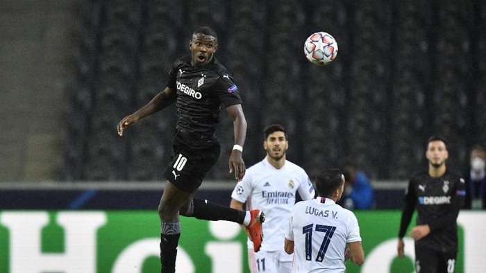 Moenchengladbachs Marcus Thuram, left, heads the ball past Real Madrids Lucas Vazquez during the Champions League group B soccer match between Borussia Moenchengladbach and Real Madrid at the Borussia Park in Moenchengladbach, Germany, Tuesday, Oct. 27, 2020. (AP Photo/Martin Meissner)