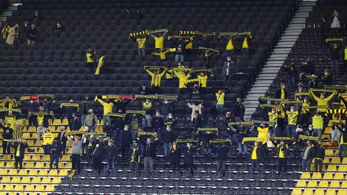 Borussia Dortmund DORTMUND, GERMANY - OCTOBER 24: Supporters of Dortmund cheer during the Bundesliga match between Borussia Dortmund and FC Schalke 04 at Signal Iduna Park on October 24, 2020 in Dortmund, Germany. A limited number of spectators (300) will be in attendance as Covid-19 pandemic restrictions are eased in Dortmund. (Photo by Martin Rose/Getty Images)