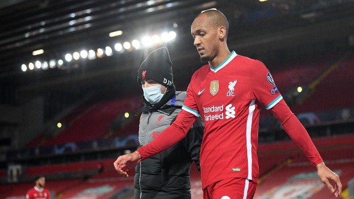 LIVERPOOL, ENGLAND - OCTOBER 27:  Fabinho of Liverpool walks around the pitch after he sustains an injury during the UEFA Champions League Group D stage match between Liverpool FC and FC Midtjylland at Anfield on October 27, 2020 in Liverpool, England. Sporting stadiums around the UK remain under strict restrictions due to the Coronavirus Pandemic as Government social distancing laws prohibit fans inside venues resulting in games being played behind closed doors. (Photo by Michael Regan/Getty Images)