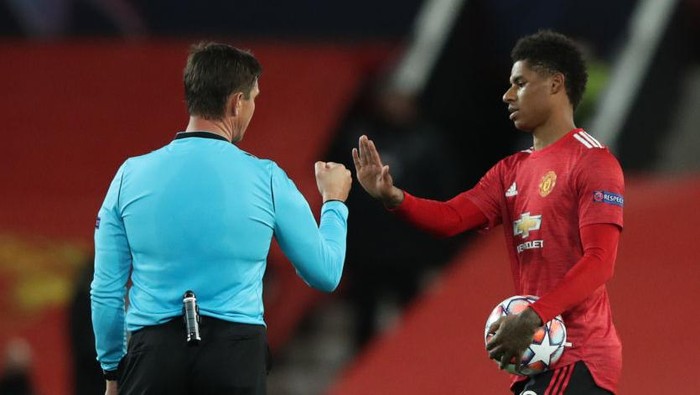 MANCHESTER, ENGLAND - OCTOBER 28: Marcus Rashford of Manchester United interacts with Match Referee Matej Jug following the UEFA Champions League Group H stage match between Manchester United and RB Leipzig at Old Trafford on October 28, 2020 in Manchester, England. Sporting stadiums around the UK remain under strict restrictions due to the Coronavirus Pandemic as Government social distancing laws prohibit fans inside venues resulting in games being played behind closed doors. (Photo by Clive Brunskill/Getty Images)