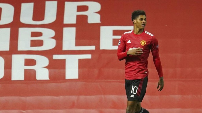 Manchester Uniteds Marcus Rashford celebrates after scoring his sides second goal during the Champions League group H soccer match between Manchester United and RB Leipzig, at the Old Trafford stadium in Manchester, England, Wednesday, Oct. 28, 2020. (AP Photo/Dave Thompson)