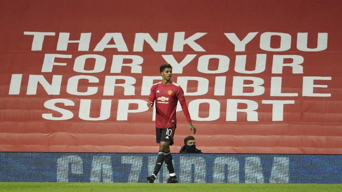 Manchester Uniteds Marcus Rashford celebrates after scoring his sides second goal during the Champions League group H soccer match between Manchester United and RB Leipzig, at the Old Trafford stadium in Manchester, England, Wednesday, Oct. 28, 2020. (AP Photo/Dave Thompson)