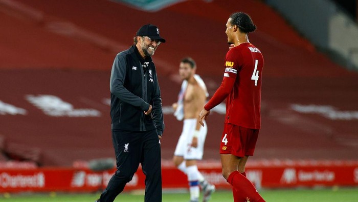 LIVERPOOL, ENGLAND - JUNE 24: Jurgen Klopp, Manager of Liverpool celebrates with Virgil van Dijk of Liverpool after the Premier League match between Liverpool FC and Crystal Palace at Anfield on June 24, 2020 in Liverpool, England. (Phil Noble/Pool via Getty Images)