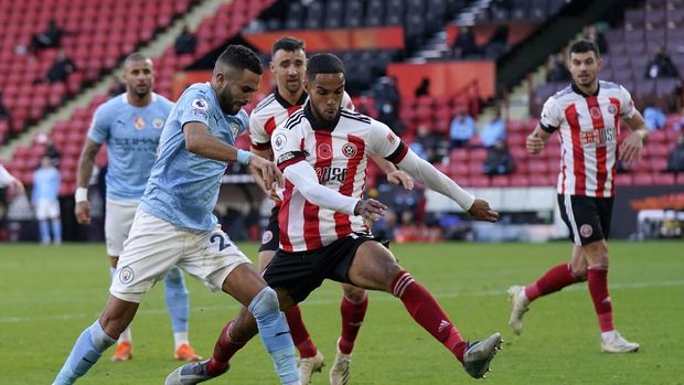 Manchester City's Riyad Mahrez, left, duels for the ball with Sheffield United's Max Lowe during the English Premier League soccer match between Sheffield United and Manchester City at Bramall Lane stadium in Sheffield, England, Saturday, Oct. 31, 2020. (Tim Keeton/Pool via AP)