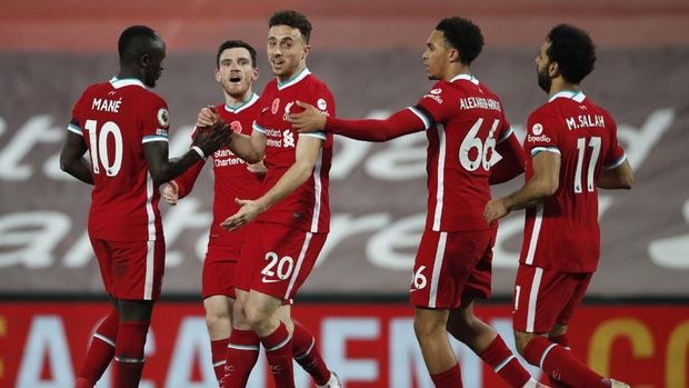 Liverpool's Diogo Jota, centre, celebrates scoring his sides second goal during the English Premier League soccer match between Liverpool and West Ham United at Anfield stadium in Liverpool, England, Saturday, Oct. 31, 2020. (Clive Brunskill/Pool via AP)