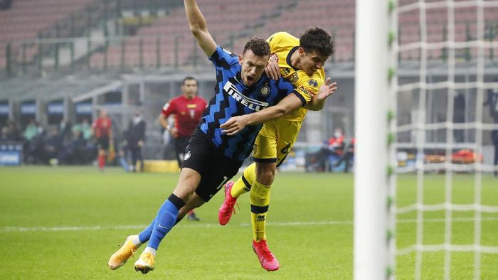 Inter vs Parma Inter Milans Ivan Perisic, left, challenges for the ball with Parmas Botond Balogh during the Serie A soccer match between Inter Milan and Parma at the San Siro Stadium, in Milan, Italy, Saturday, Oct. 31, 2020. (AP Photo/Antonio Calanni)