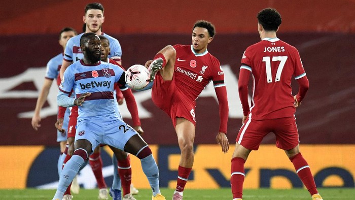 LIVERPOOL, ENGLAND - OCTOBER 31: Trent Alexander-Arnold of Liverpool is challenged by Arthur Masuaku of West Ham United during the Premier League match between Liverpool and West Ham United at Anfield on October 31, 2020 in Liverpool, England. Sporting stadiums around the UK remain under strict restrictions due to the Coronavirus Pandemic as Government social distancing laws prohibit fans inside venues resulting in games being played behind closed doors. (Photo by Peter Powell - Pool/Getty Images)