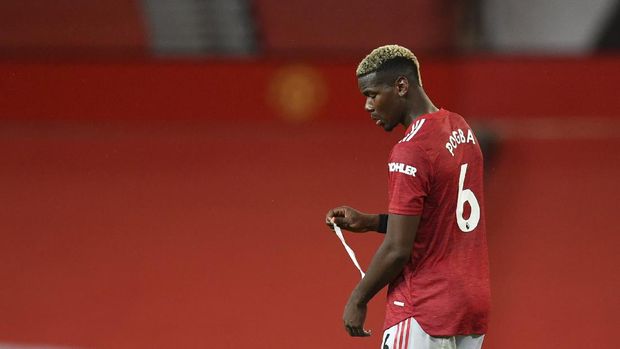 Manchester United's Paul Pogba walks in dejection end of the English Premier League soccer match between Manchester United and Arsenal at the Old Trafford stadium in Manchester, England, Sunday, Nov. 1, 2020. (Paul Ellis/Pool via AP)