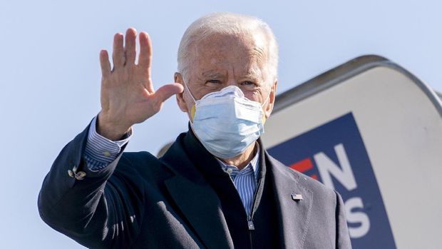 Democratic presidential candidate former Vice President Joe Biden boards his campaign plane at New Castle Airport in New Castle, Del., Saturday, Oct. 31, 2020, to travel to Flint, Mich. to campaign with former President Barack Obama. (AP Photo/Andrew Harnik)