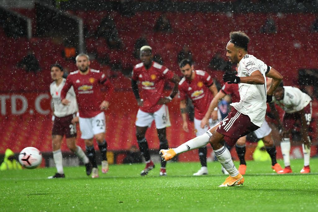 MANCHESTER, ENGLAND - NOVEMBER 01: Pierre-Emerick Aubameyang of Arsenal scores a penalty for his team's first goal  during the Premier League match between Manchester United and Arsenal at Old Trafford on November 01, 2020 in Manchester, England. Sporting stadiums around the UK remain under strict restrictions due to the Coronavirus Pandemic as Government social distancing laws prohibit fans inside venues resulting in games being played behind closed doors. (Photo by Shaun Botterill/Getty Images)